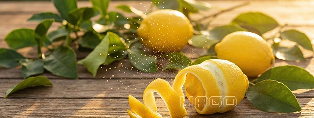 Fresh lemons and peels releasing essential oil